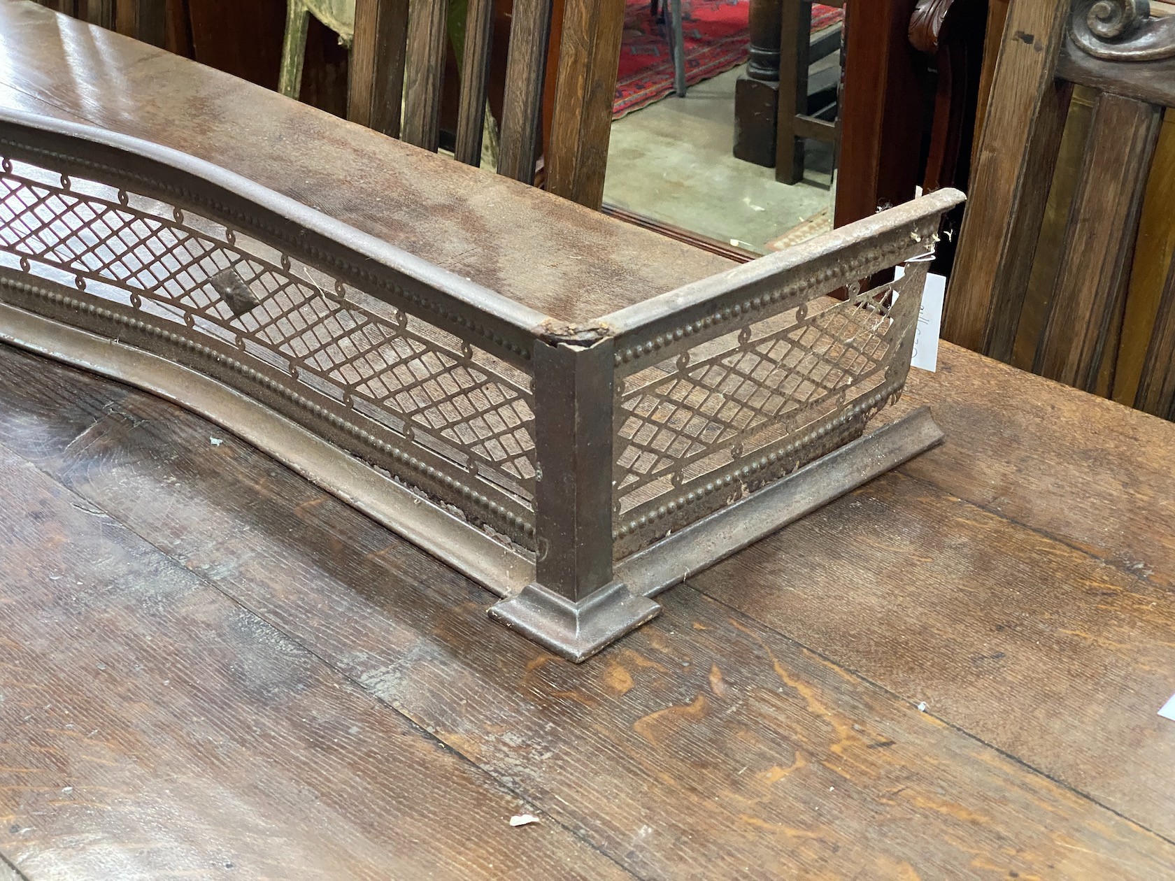 A George III serpentine steel fire curb, width 158cm